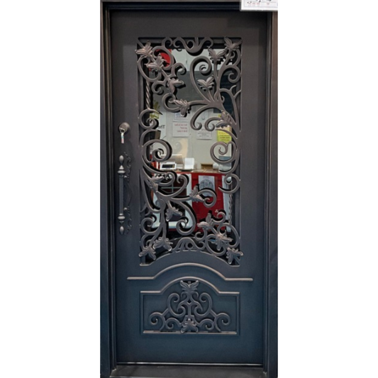 Decorative black metal door with intricate designs and glass panel
